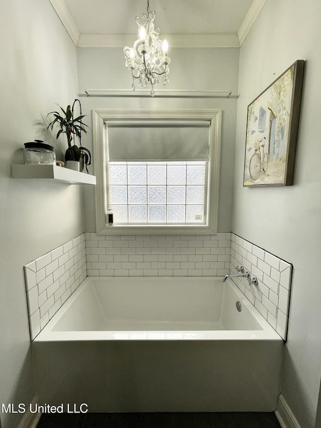 bathroom with a bathtub, crown molding, and a notable chandelier