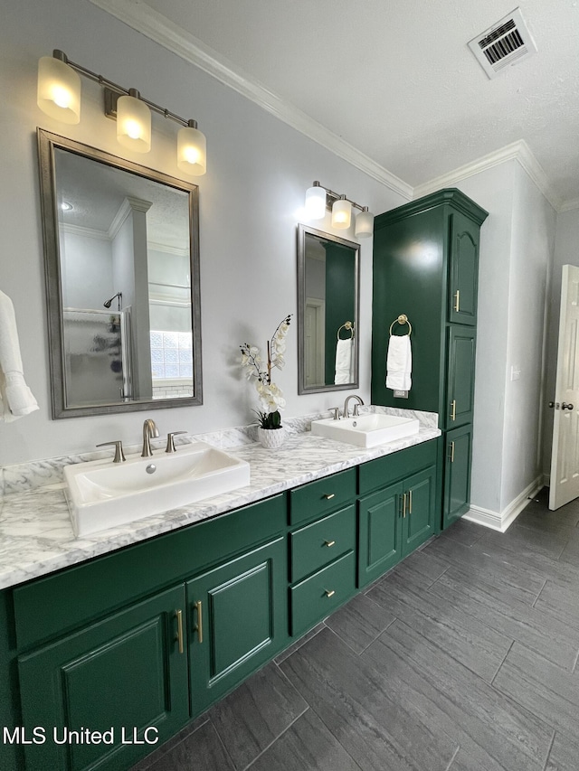 bathroom featuring ornamental molding, hardwood / wood-style floors, vanity, and walk in shower