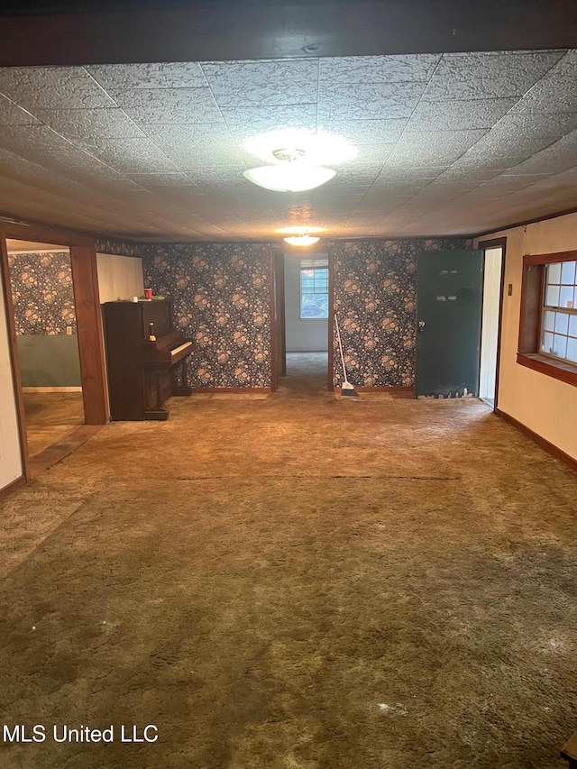 below grade area featuring carpet floors and baseboards