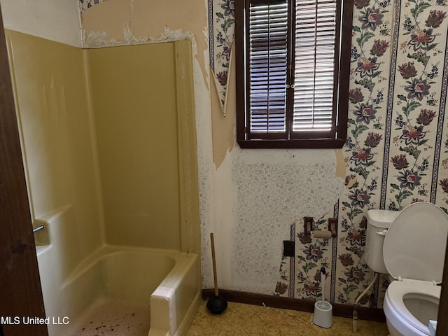 bathroom featuring toilet and baseboards