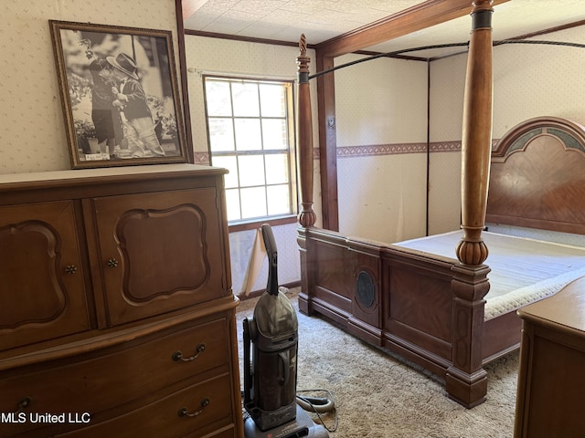 carpeted bedroom featuring wallpapered walls and ornamental molding