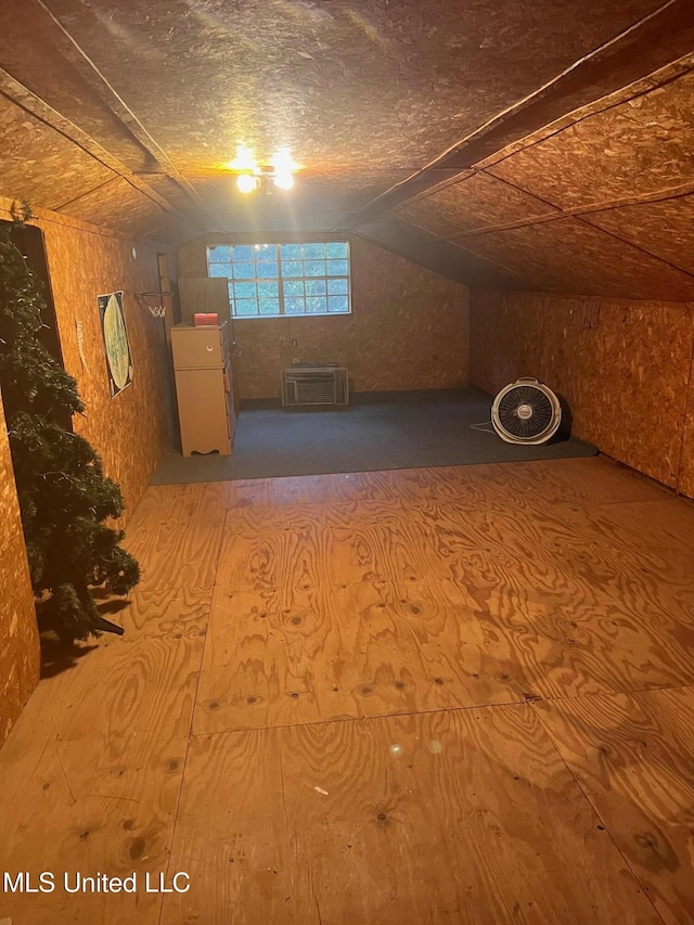additional living space featuring lofted ceiling