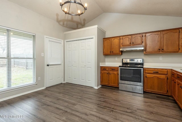 kitchen with under cabinet range hood, brown cabinets, and electric range