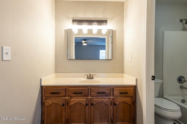 bathroom with toilet, shower / bathtub combination, and vanity