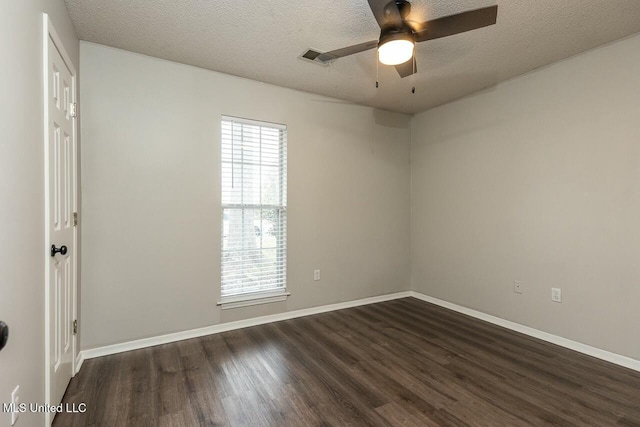 unfurnished room with dark wood-style floors, ceiling fan, baseboards, and a textured ceiling