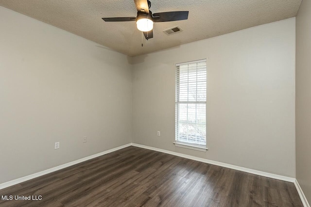 unfurnished room with a textured ceiling, ceiling fan, dark wood-type flooring, visible vents, and baseboards