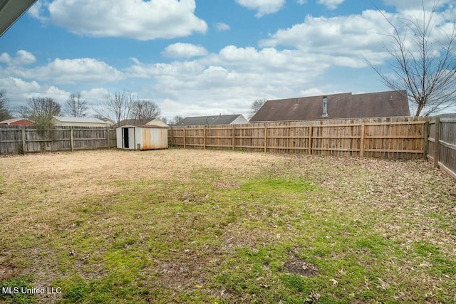 view of yard featuring a fenced backyard, an outdoor structure, and a shed