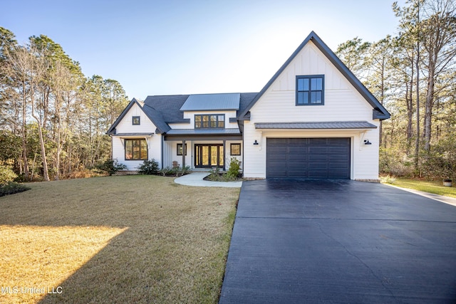 modern farmhouse style home with a front yard and a garage