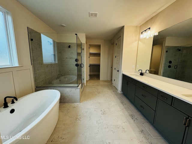 bathroom featuring shower with separate bathtub and vanity