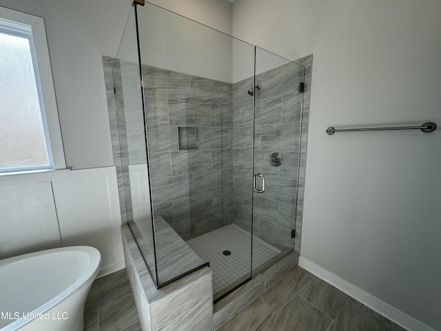 bathroom with separate shower and tub