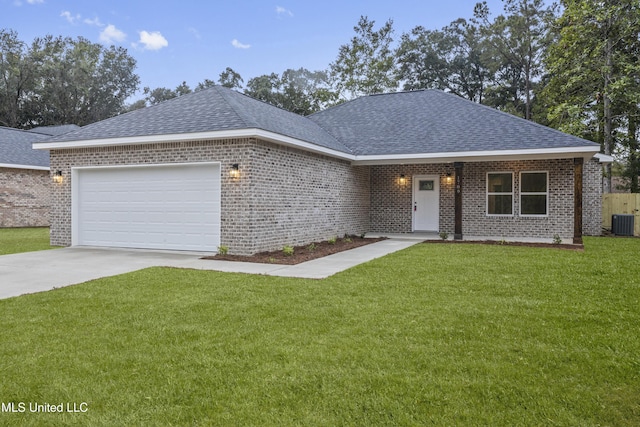 view of front of property with central AC, a front yard, and a garage