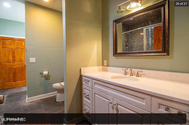 bathroom with vanity, an enclosed shower, and toilet