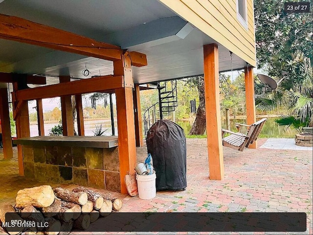 view of patio featuring a bar and a grill