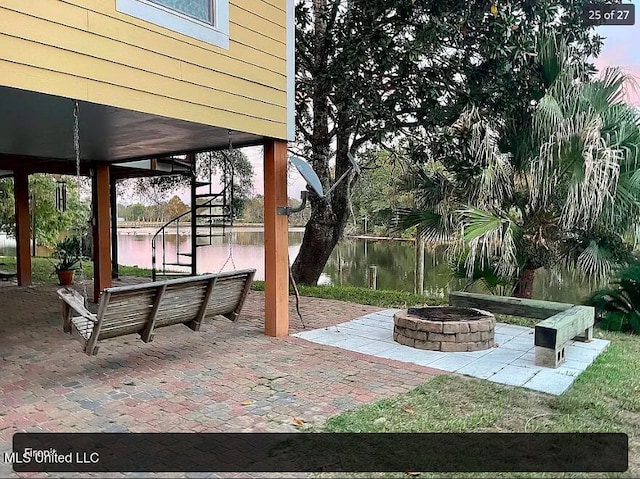 view of patio / terrace featuring a water view and an outdoor fire pit