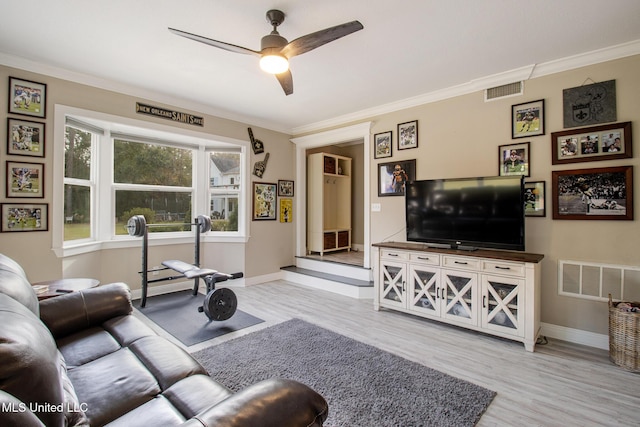 living room with ceiling fan, light hardwood / wood-style flooring, and ornamental molding