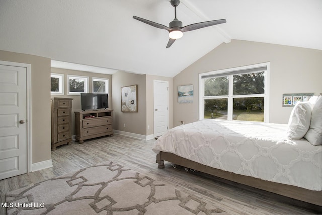 bedroom with light wood-type flooring, lofted ceiling with beams, and ceiling fan