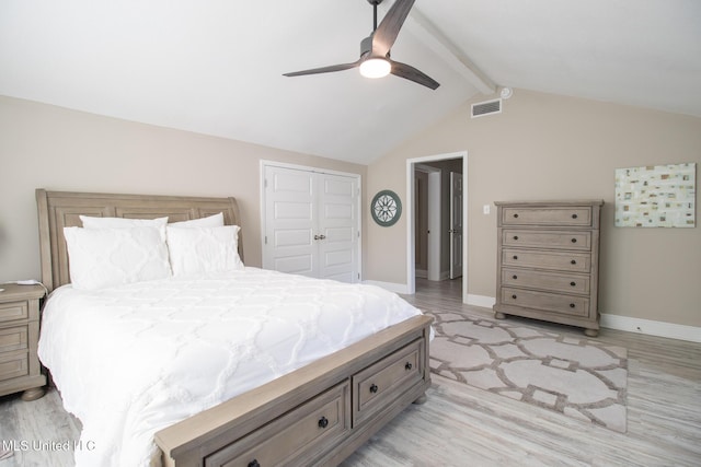 bedroom featuring vaulted ceiling with beams, ceiling fan, a closet, and light hardwood / wood-style flooring