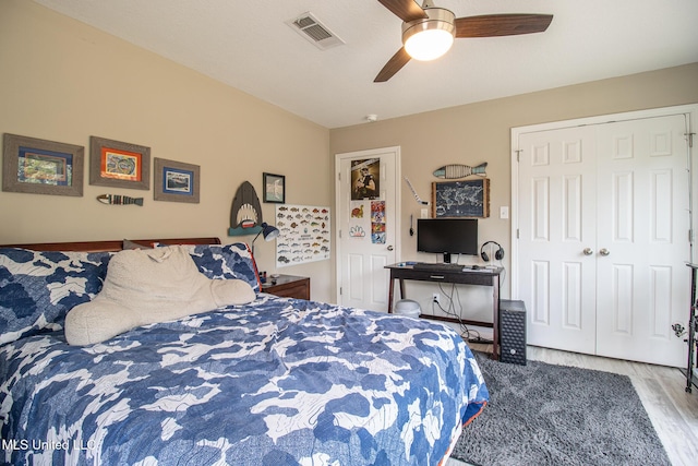 bedroom with a closet, ceiling fan, and light hardwood / wood-style flooring