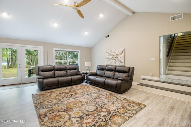 living room featuring french doors, ceiling fan, beam ceiling, high vaulted ceiling, and light hardwood / wood-style floors