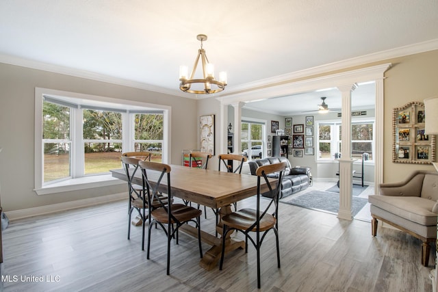 dining room with hardwood / wood-style floors, ceiling fan with notable chandelier, and crown molding