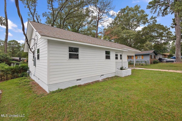 view of side of property with a yard