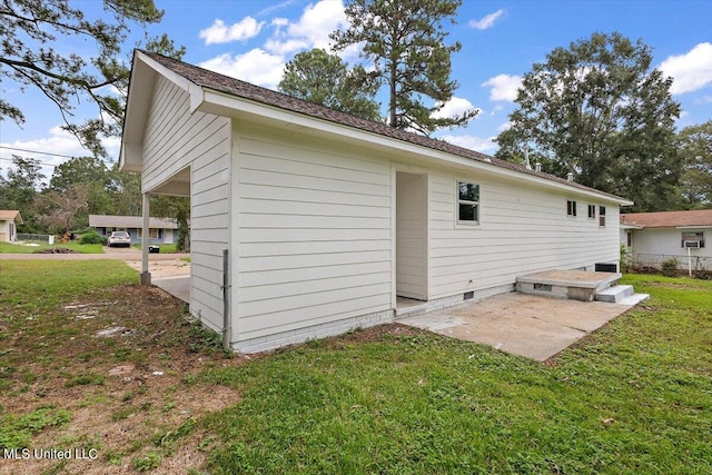 back of property featuring a patio area and a lawn