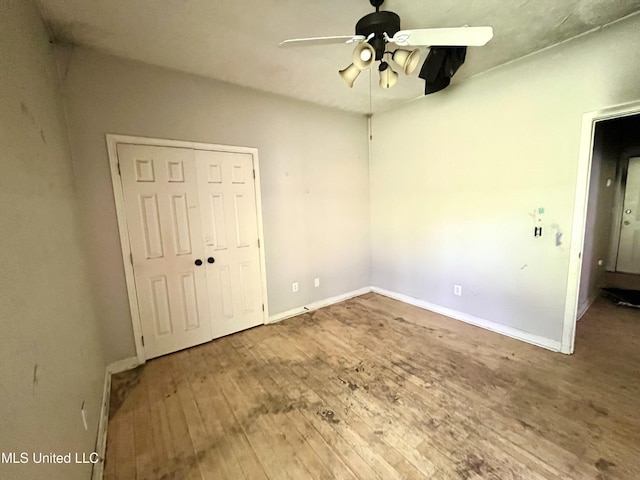 231 Clark Farms Rd, Madison, MS 39110 - unfurnished bedroom with hardwood / wood-style floors, baseboards, a closet, and a ceiling fan