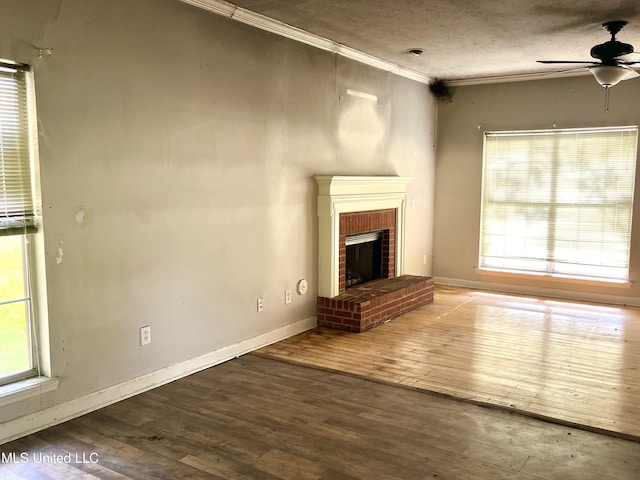 231 Clark Farms Rd, Madison, MS 39110 - unfurnished living room with ceiling fan, wood finished floors, crown molding, a brick fireplace, and baseboards