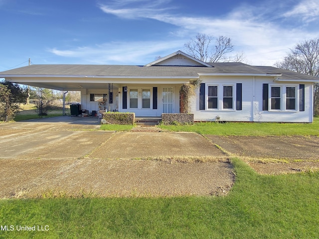 ranch-style home with a front yard and a carport