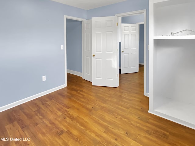 unfurnished room featuring wood-type flooring