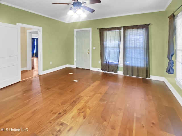 unfurnished room with ceiling fan, hardwood / wood-style floors, and ornamental molding