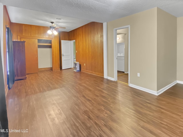 interior space featuring ceiling fan, a textured ceiling, and hardwood / wood-style flooring