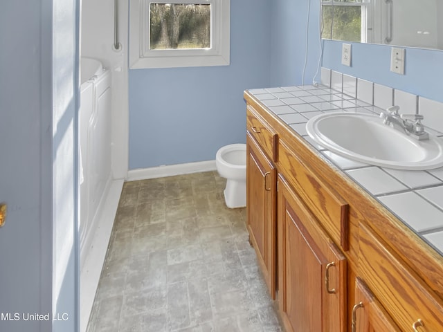 bathroom featuring toilet and vanity