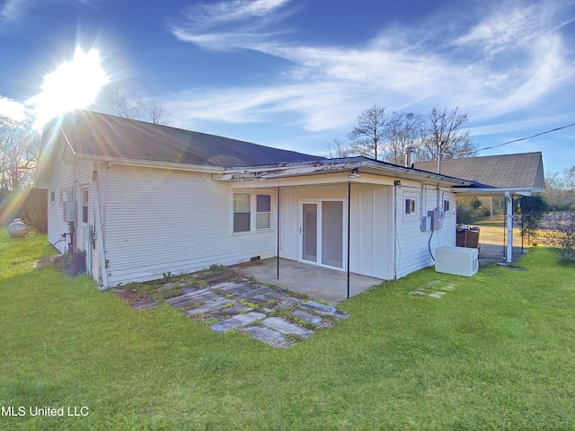 back of property featuring a patio area and a lawn