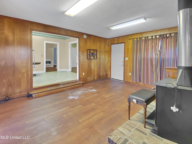 interior space featuring a textured ceiling and hardwood / wood-style floors