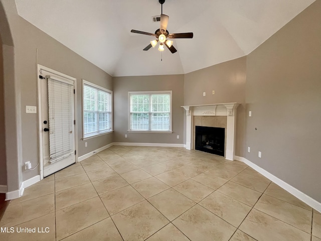 7309 Gerralyn Cv, Olive Branch, MS 38654 - unfurnished living room featuring light tile patterned floors, ceiling fan, high vaulted ceiling, and a tiled fireplace