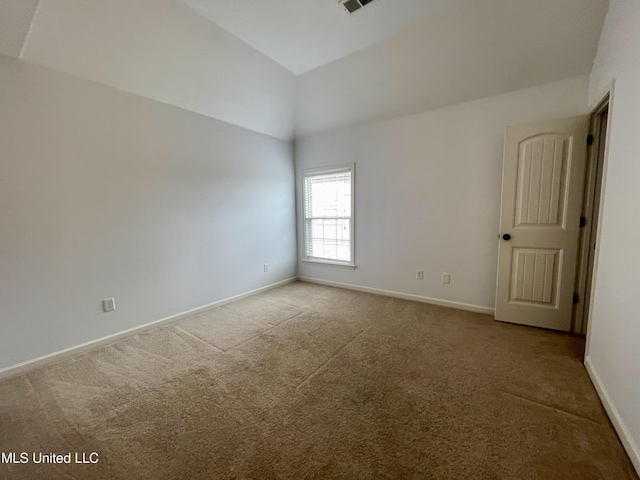 7309 Gerralyn Cv, Olive Branch, MS 38654 - carpeted spare room featuring baseboards and vaulted ceiling