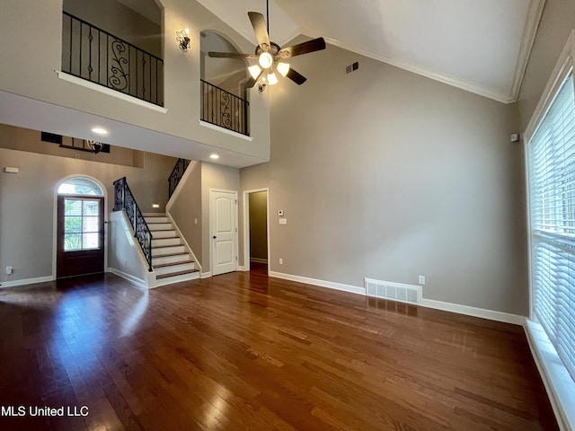 7309 Gerralyn Cv, Olive Branch, MS 38654 - unfurnished living room with ceiling fan, stairs, wood finished floors, high vaulted ceiling, and crown molding