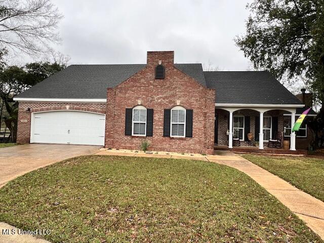 view of front facade featuring a garage, concrete driveway, brick siding, and a chimney