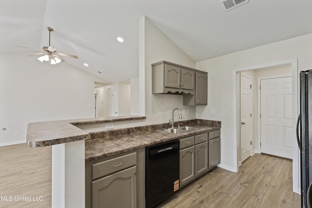 7306 George Ln, Horn Lake, MS 38637 - kitchen featuring dishwasher, lofted ceiling, dark countertops, a sink, and a peninsula