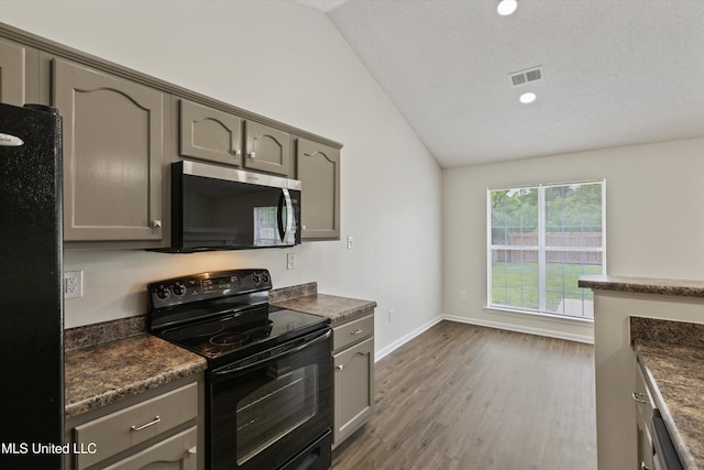 7306 George Ln, Horn Lake, MS 38637 - kitchen with black appliances, dark countertops, lofted ceiling, gray cabinets, and recessed lighting