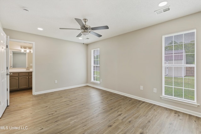 7306 George Ln, Horn Lake, MS 38637 - unfurnished bedroom with light wood-type flooring, baseboards, recessed lighting, ensuite bath, and a ceiling fan