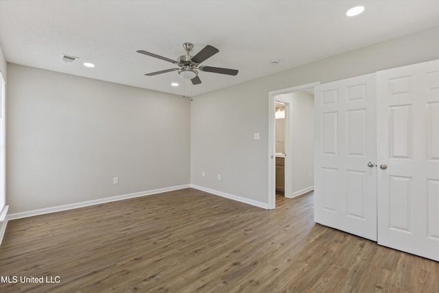 7306 George Ln, Horn Lake, MS 38637 - unfurnished bedroom with recessed lighting, wood finished floors, baseboards, a ceiling fan, and a closet