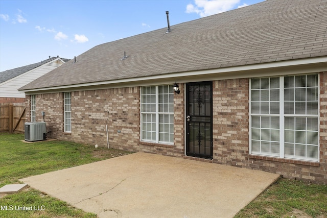 7306 George Ln, Horn Lake, MS 38637 - back of property featuring a patio, roof with shingles, brick siding, and central air condition unit