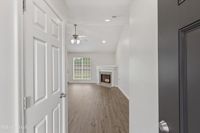 7306 George Ln, Horn Lake, MS 38637 - unfurnished living room with ceiling fan, wood finished floors, vaulted ceiling, a fireplace, and baseboards