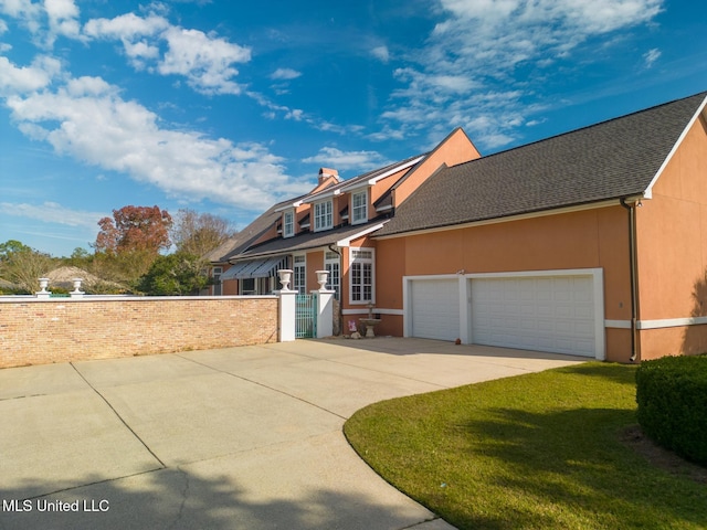 view of front facade with a garage and a front lawn