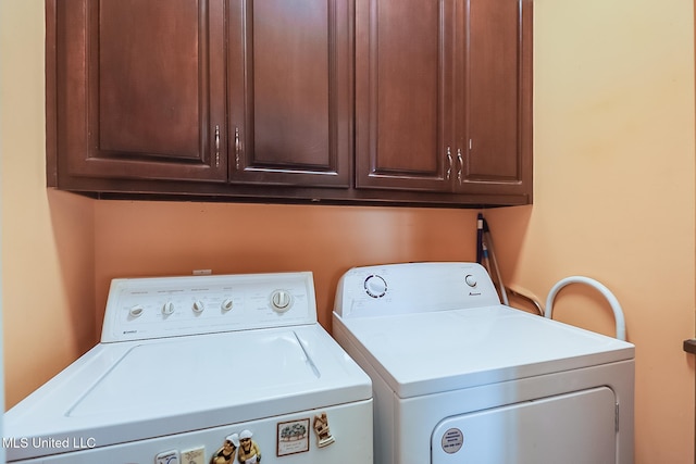 laundry area featuring cabinets and washing machine and clothes dryer