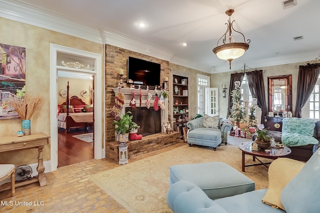 living room featuring built in shelves, crown molding, a brick fireplace, and hardwood / wood-style flooring