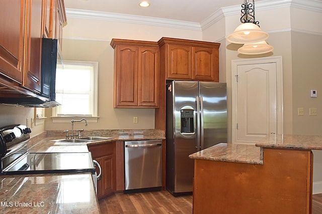 30 Oak Alley Ln, Long Beach, MS 39560 - kitchen with stainless steel appliances, brown cabinets, wood finished floors, decorative light fixtures, and ornamental molding