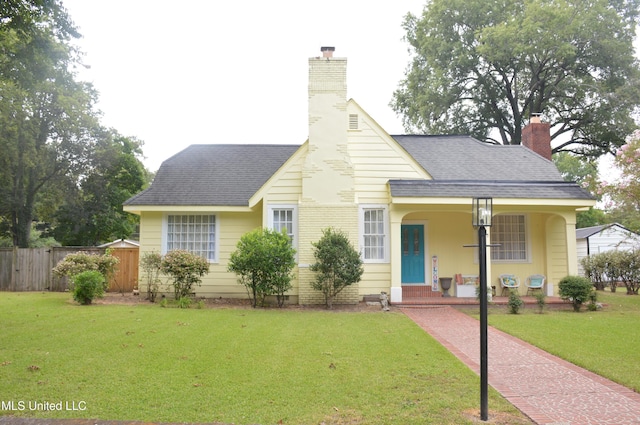 view of front of home with a porch and a front yard